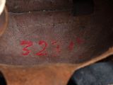 a close up of a person ' s shoe with red writing on it