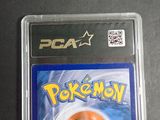 a pokemon card in a plastic case on a table