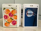 two boxes with pictures of oranges on them sitting on a table