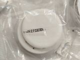 a close up of a white button on a plastic bag
