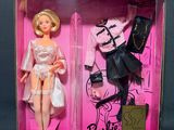 pink box with two barbie dolls in it on a black background
