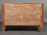 an old wooden chest sitting on top of a floor next to a gray wall