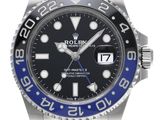 a close up of a rolex watch with a blue bezel