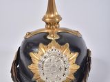 an image of a black and gold helmet with a gold crown on top