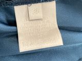 a close up of a label on the back of a blue jacket