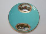 a blue plate with a picture of horses on it