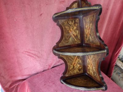 a wooden shelf with a decorative design on it