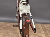 a wooden rocking horse with a helmet on top of it
