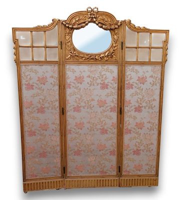 an image of a gold colored room divider with a mirror above it