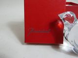 a red box with a glass bird next to it