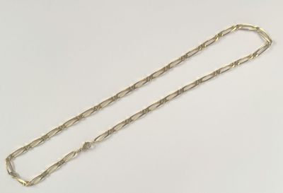 a close up of a gold chain on a white surface