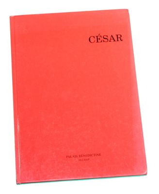 a red book sitting on top of a white table