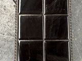 a metal tray with six squares of glass in it