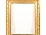 an antique gold frame with a white background