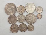 some of the coins are sitting on a white surface