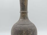 an old vase sitting on a white surface with a white background
