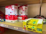 many boxes of food sitting on a shelf in a store