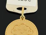 a close up of a gold coin with a tag attached to it