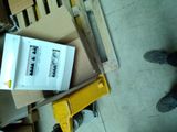 a cardboard box on a pallet next to a pair of shoes