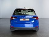 the rear end of a blue volkswagen v - cross parked in a white room