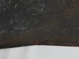 a piece of metal that has been rusted off and is sitting on a white surface