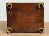 a small wooden box with two handles on a table