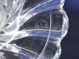 a close up of a clear glass vase with a flower inside of it