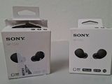 two boxes of sony earphones sitting next to each other on a table
