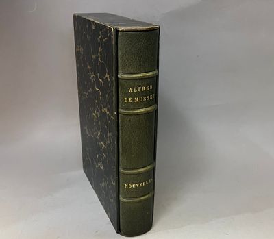 an old book sitting on top of a table next to a white background