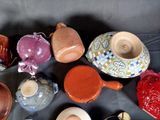 many different types of pottery sitting on a table
