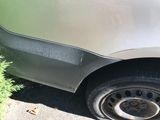 a close up of a car ' s tire on the side of the road