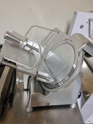 a large slicer that is sitting on top of a counter