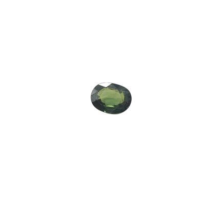a close up of a green stone on a white surface