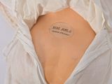 a white dress with a label on the back of it