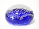 a blue glass ball with a design on it