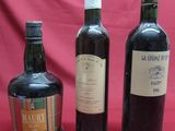 three bottles of wine sitting next to each other on a table
