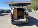 the back of a van with its doors open in a parking lot