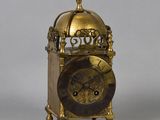 a gold clock with a dome on top of it