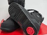black and red shoes on top of a red box in a room