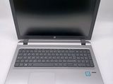an open laptop computer sitting on top of a white table