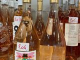 several bottles of wine are lined up on a counter