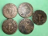 four different types of coins sitting on top of a green surface