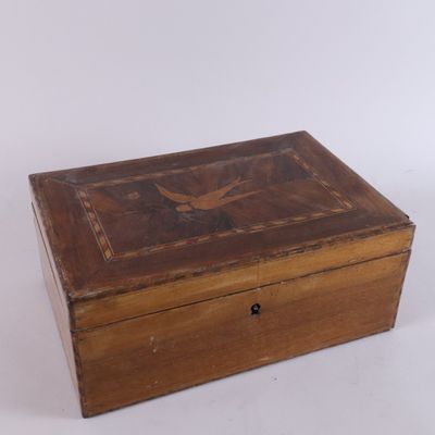 an old wooden box sitting on top of a white surface