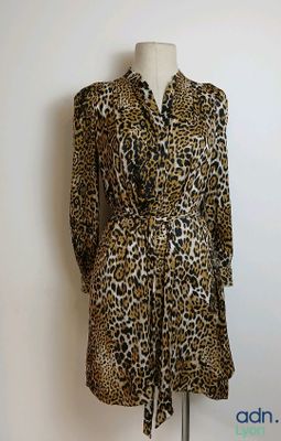 an image of a leopard print dress on a mannequin stand