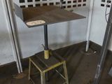 a small table and a stool in a room