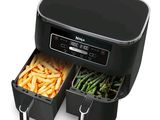 une friteuse à air chaud noire contenant des frites et des asperges