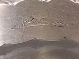 a close up of a silver plate with writing on it