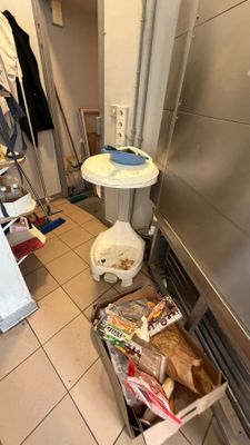 an image of a kitchen with a sink and a trash can