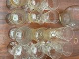 many empty wine glasses sitting on a wooden table