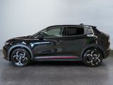 a black suv parked in a room with a white wall